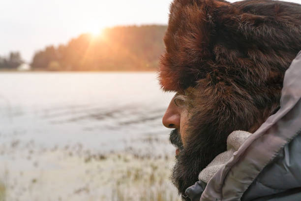 istock Man in nature looking away with ushanka on head 936310502