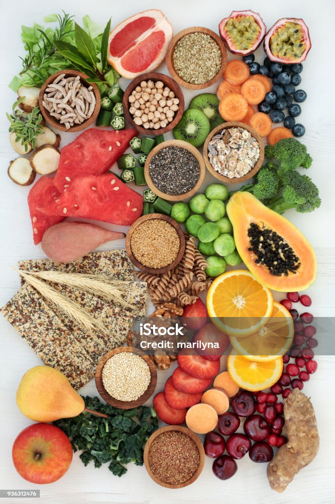 Healthy High Fiber Diet Food Healthy high fibre dietary food concept with fruit, vegetables, nuts, seeds, cereals, whole grain seeded crackers, whole wheat pasta and herbs. Foods high in antioxidants, anthocyanins, omega 3 fatty acids and vitamins. Blueberry Stock Photo