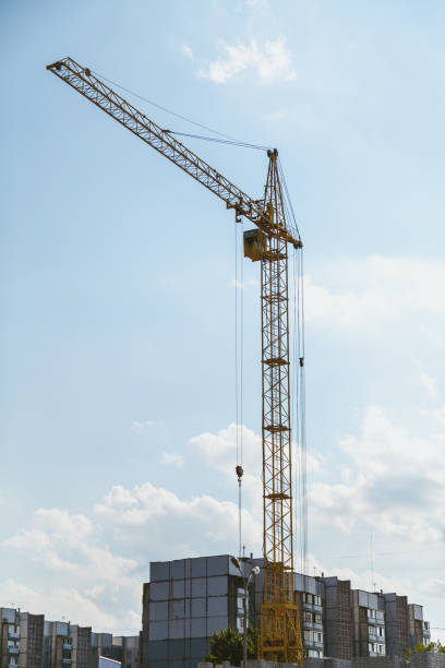 istock Lifting tower crane against cloudy sky background 936313314