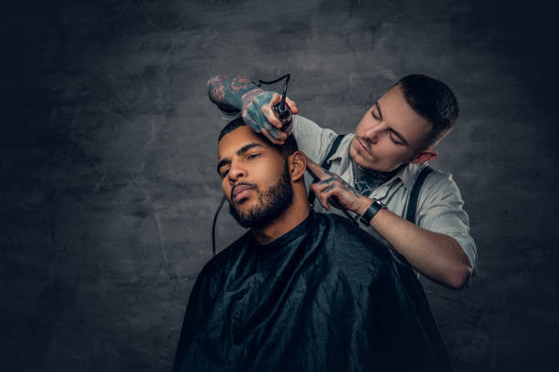 istock Male barber cutting the beard to Black stylish man. 936313676