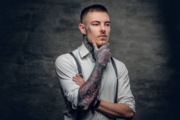istock A man with a tattoo on his face and arms. 936313826