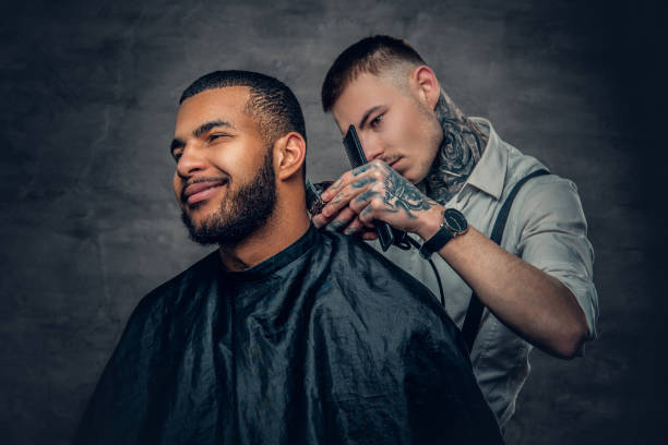 istock Male barber cutting the beard to Black stylish man. 936314172