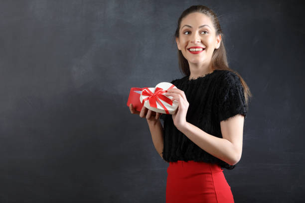 istock Beautiful Young Woman Holding Gift Box 936318808