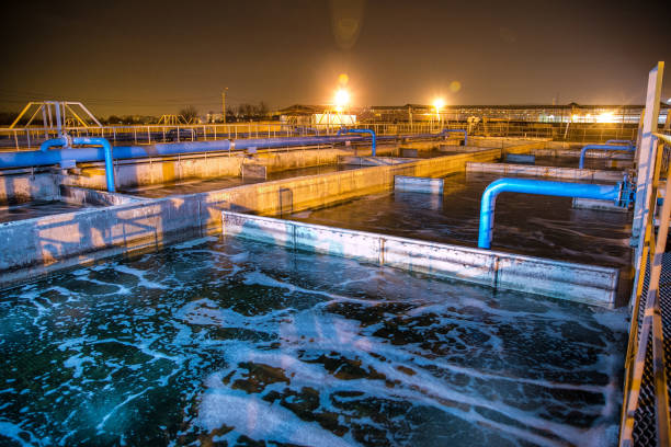 Modern wastewater treatment plant of chemical factory at night. Water purification tanks Modern wastewater treatment plant of chemical factory at night. Water purification tanks. reservoir stock pictures, royalty-free photos & images