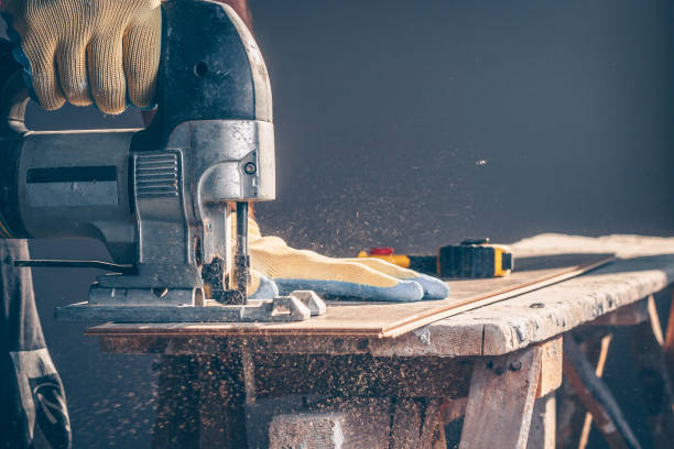 istock The worker cuts boards with an electric jigsaw 936322912