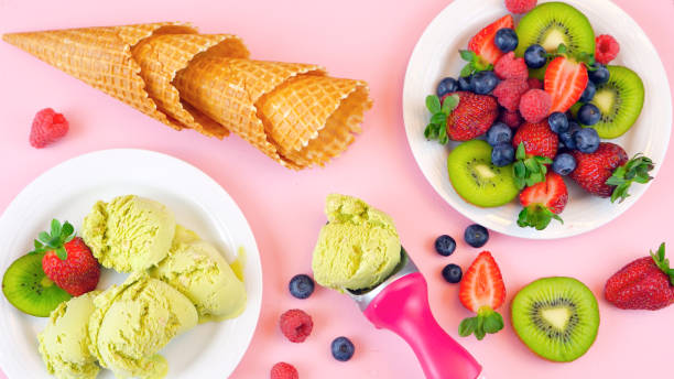istock Matcha Green Tea ice cream with waffle cones and fresh fruit overhead flat lay 936323164