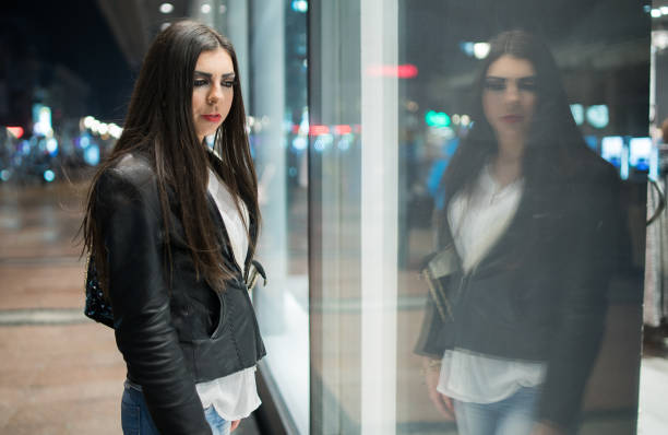 istock Young Caucasian woman with reflection in a glass 936323994