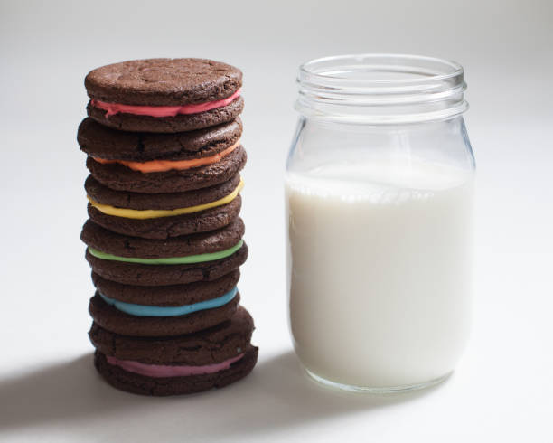 Rainbow Sandwich Cookies with Milk stock photo
