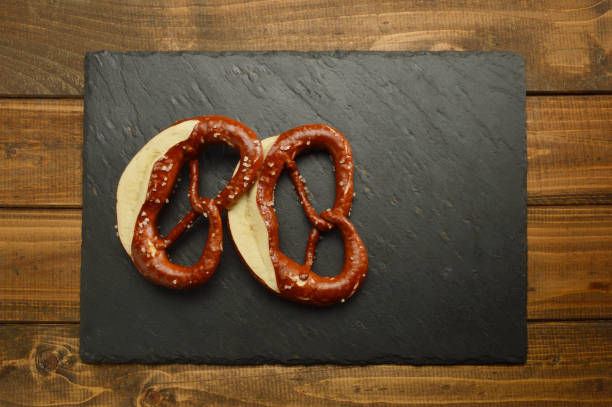 pretzels on black stone plate - baking traditional culture studio shot horizontal imagens e fotografias de stock