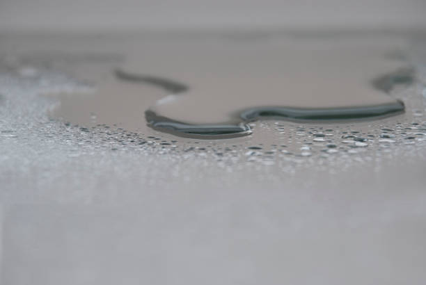 horizontal abstract water drops on silver background, no people.