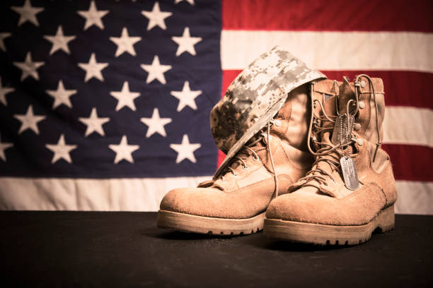 USA Military boots, hat and dog tags with flag. USA military boots, hat and dog tags with American flag in background. No people in this Memorial Day or Veteran's Day image. usa flag shoes stock pictures, royalty-free photos & images