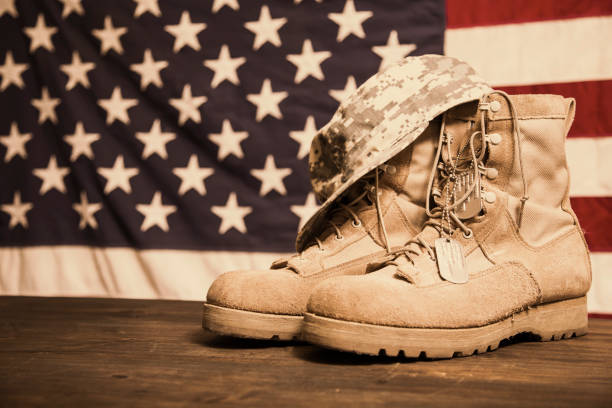 istock USA Military boots, hat and dog tags with flag. 936331052