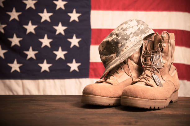 istock USA Military boots, hat and dog tags with flag. 936331074