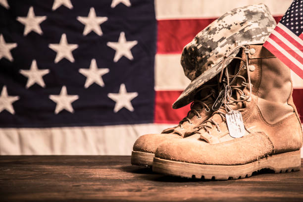 istock USA Military boots, hat and dog tags with flag. 936331114