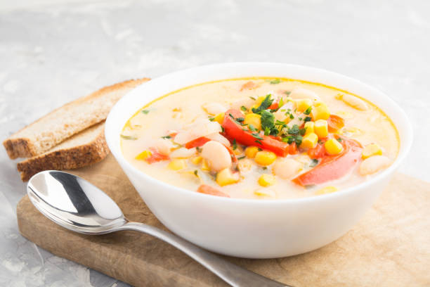 istock Soup with cream, corn, beans, bell peppers and onion with toast bread 936336220