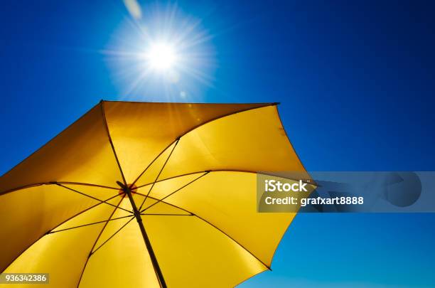 Yellow Umbrella With Bright Sun And Blue Sky Stock Photo - Download Image Now - Sun, Heat - Temperature, Sunlight