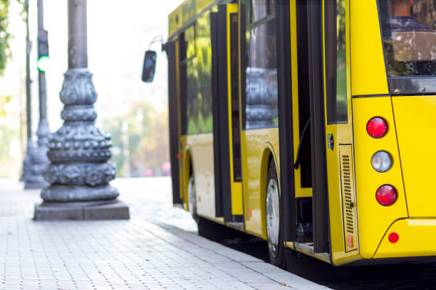 istock Modern yellow city bus with open doors at bus station 936343450