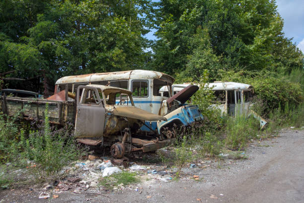 istock Old rusty trucks and buses at abandoned industrial area 936345544