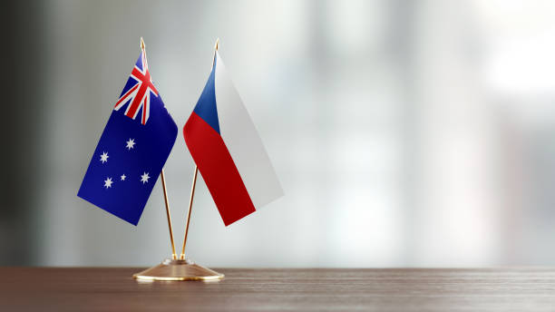 istock Australian And Czechoslovakian Flag Pair On A Desk Over Defocused Background 936346220