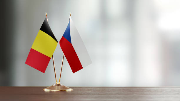 istock Belgian And Czechoslovakian Flag Pair On A Desk Over Defocused Background 936346446