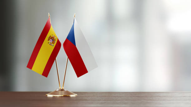 istock Spanish And Czechoslovakian Flag Pair On A Desk Over Defocused Background 936346540