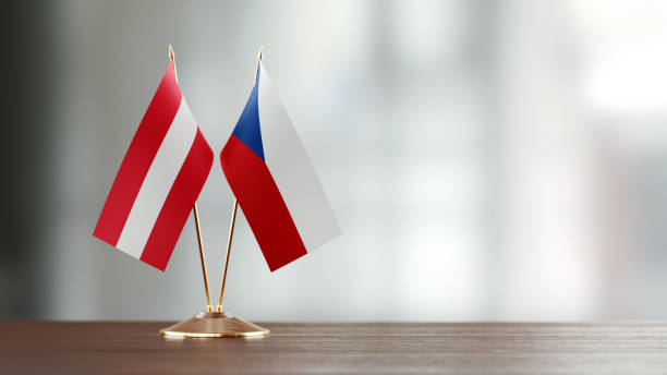 istock Austrian And Czechoslovakian Flag Pair On A Desk Over Defocused Background 936346566