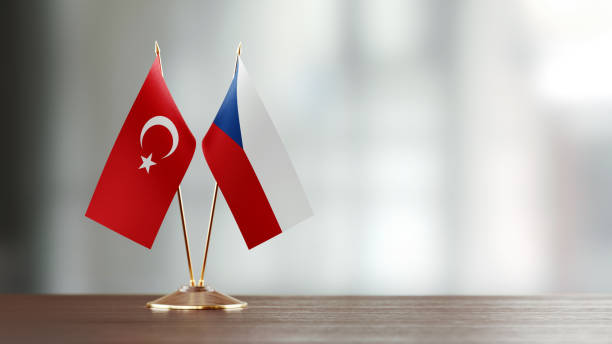 istock Turkish And Czechoslovakian Flag Pair On A Desk Over Defocused Background 936346678