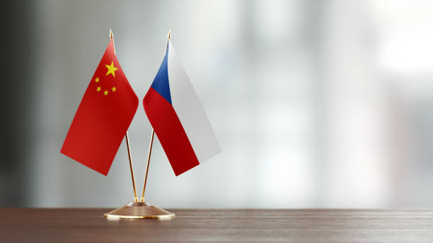 istock Chinese And Czechoslovakian Flag Pair On A Desk Over Defocused Background 936346808