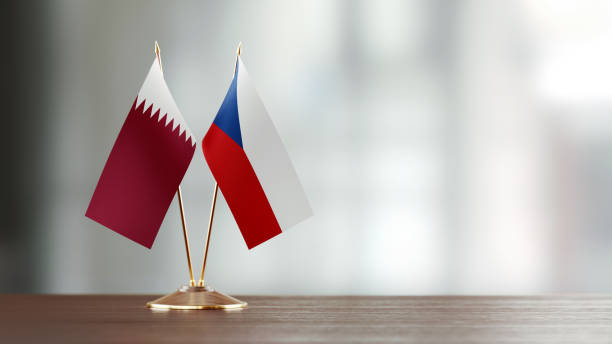 istock Qatari And Czechoslovakian Flag Pair On A Desk Over Defocused Background 936347110