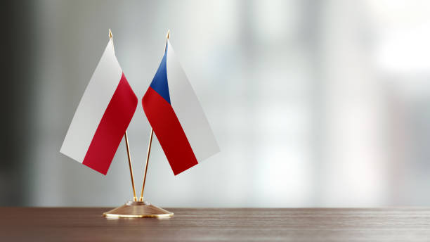 istock Polish And Czechoslovakian Flag Pair On A Desk Over Defocused Background 936347182