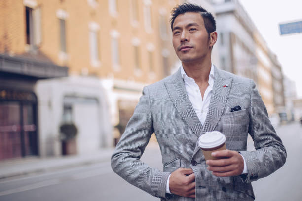 istock Businessman drinking coffee on the street 936349132