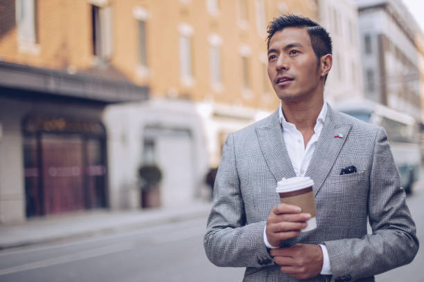 istock Man drinking coffee on the street 936349292