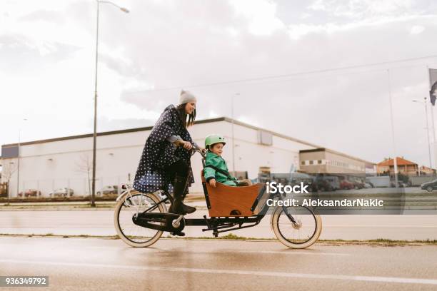 Cargo Bike Ride On The Rain Stock Photo - Download Image Now - Cargo Bike, Bicycle, Child