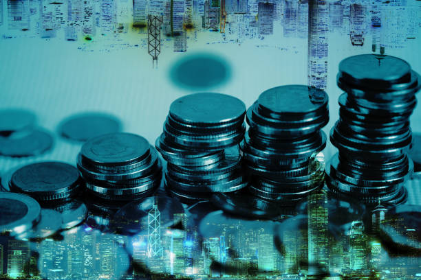 istock Double exposure of coin stack with city background and world map, financial graph, business concept. 936350366