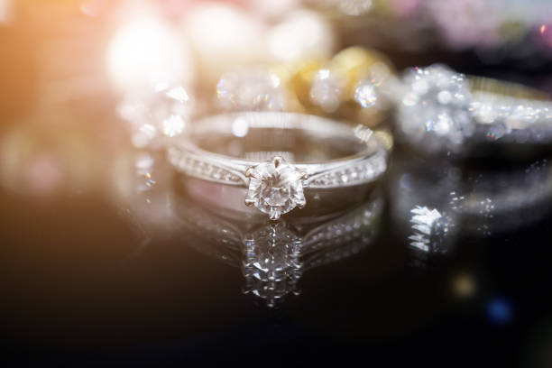 istock Jewelry diamond rings with reflection on black background 936350390