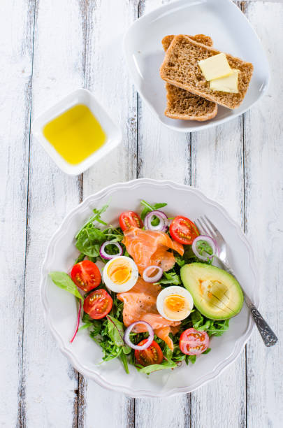 istock Smoked salmon salad with greens, tomatoes, eggs and avocado 936353356