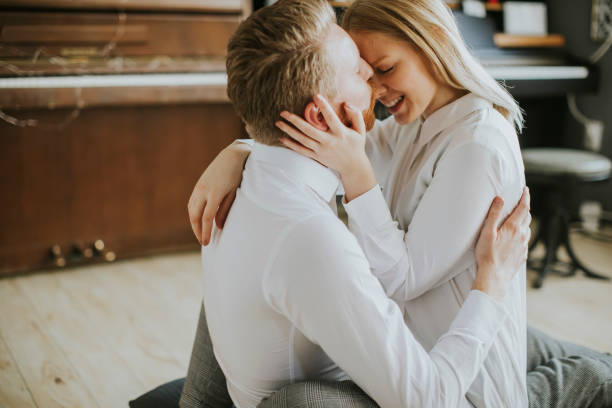 istock Loving couple kissing in the room 936355366