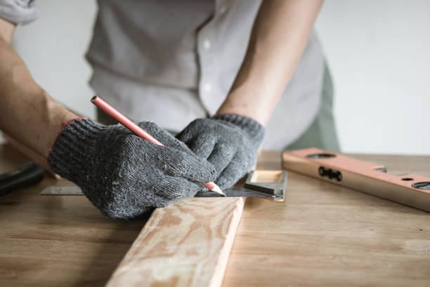 istock carpenter measuring and writing on wood with copy space background 936356002
