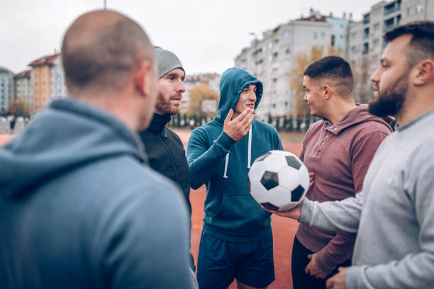 istock Best friends playing socceer on streets 936356292