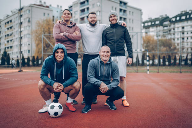 istock Best friends playing socceer on streets 936356464