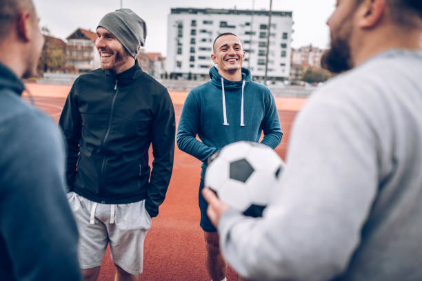 istock Best friends playing socceer on streets 936358454