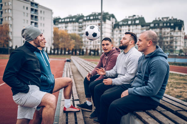 istock Best friends playing socceer on streets 936358870