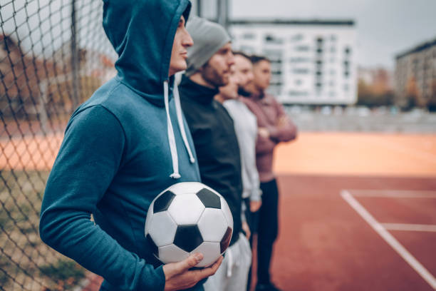 istock Best friends playing socceer on streets 936360138