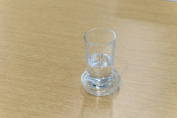 istock Glass of water on wooden table with copy space. Selective focus 936360436