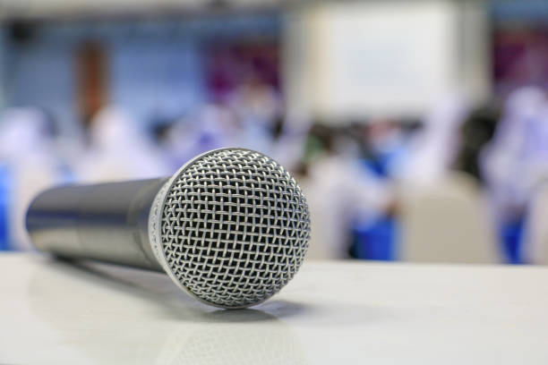 istock microphone wireless on the table in seminar conference room: Select focus with shallow depth of field. 936362012