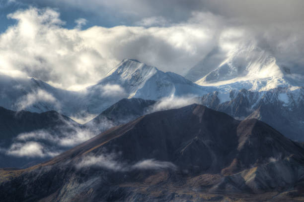 istock Mt. Denali Mountain shines beneath fog and snow. 936363024