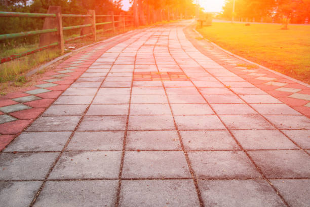 istock Stone block walk path in public park with sunset light tone: Select focus with shallow depth of field. 936363638