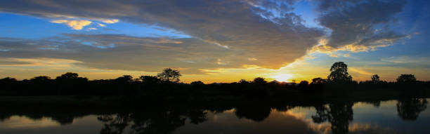 istock Panorama sunset beautiful colorful landscape and silhouette tree mountain river reflect in sky twilight time 936363684