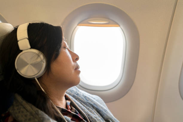 istock girl napping beside window on plane 936367418