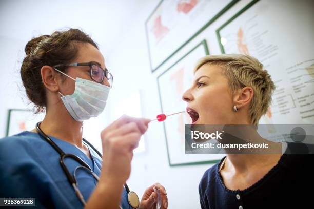 Side Close View Of Female Doctor Specialist With Face Mask Holding Buccal Cotton Swab And Test Tube Ready To Collect Dna From The Cells On The Inside Of A Woman Patient Stock Photo - Download Image Now